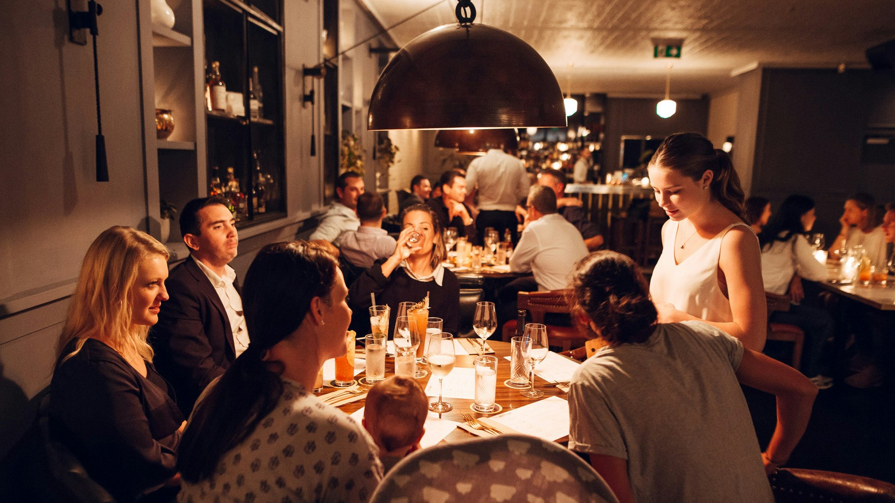 Restaurant guests dining at a Kittyhawk table.
